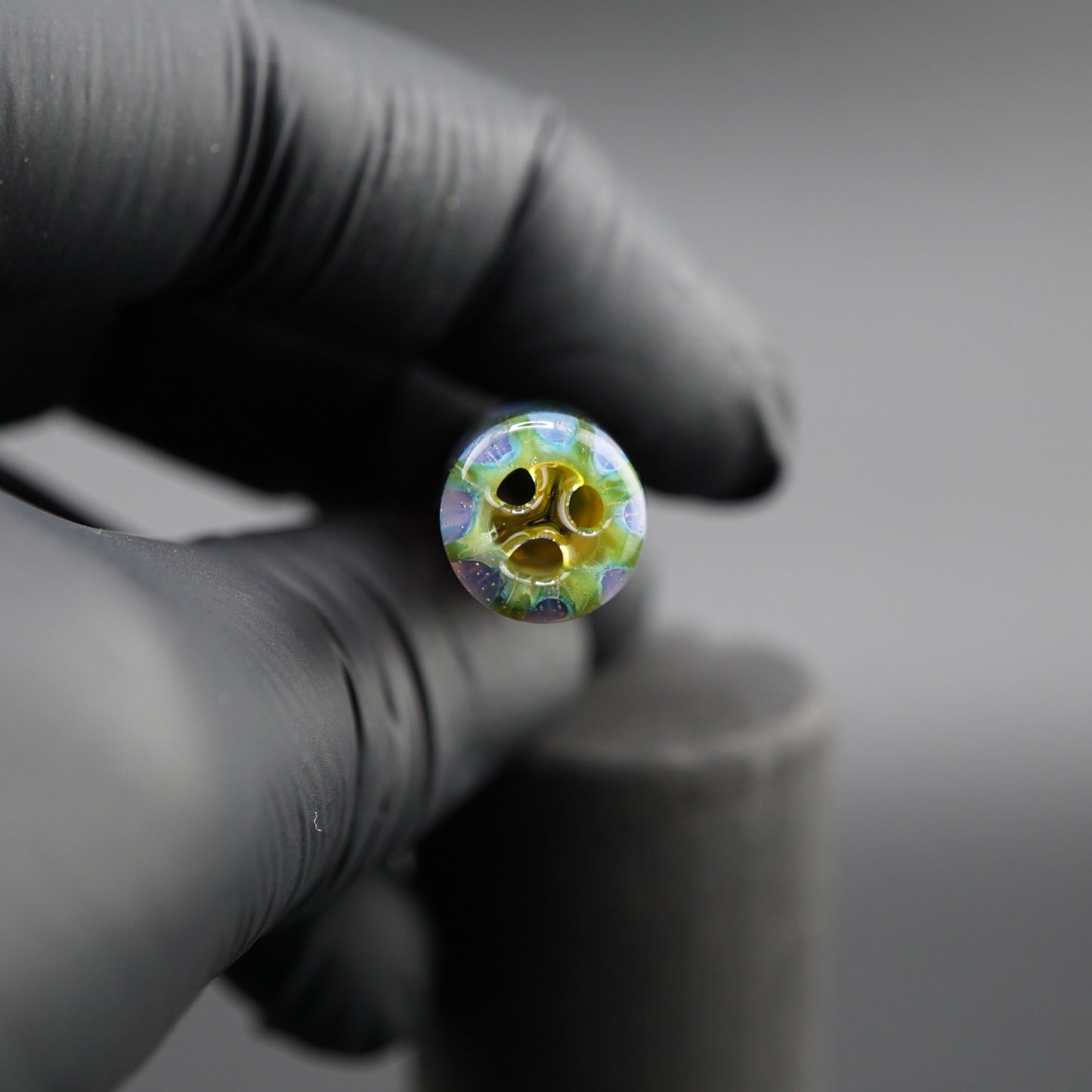 SteveHGlass 11 mm glass tip held in hand showing the multi-channel interior structure and iridescent glass design.