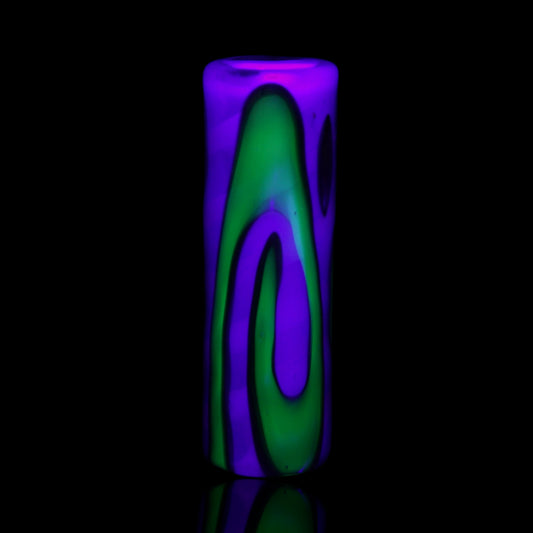 UV reactive Tyeglassarts Relic glass tip glowing bright green and purple under blacklight
