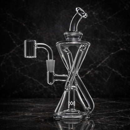 Clear glass dab rig with hourglass shape and X-percolator in dark studio setting