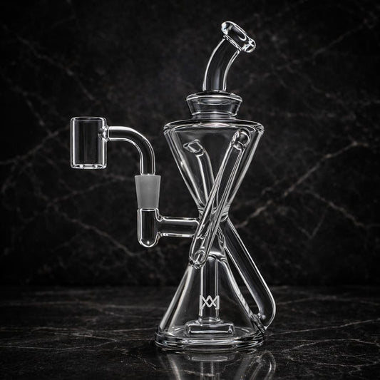 Clear glass dab rig with hourglass shape and X-percolator in dark studio setting