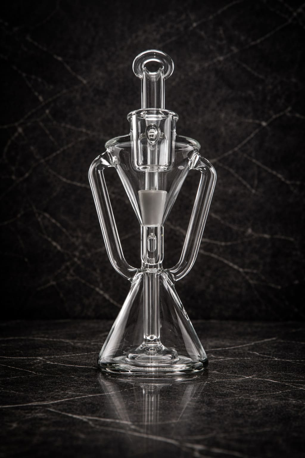 Clear glass recycler dab rig shown from the front in a dark studio environment