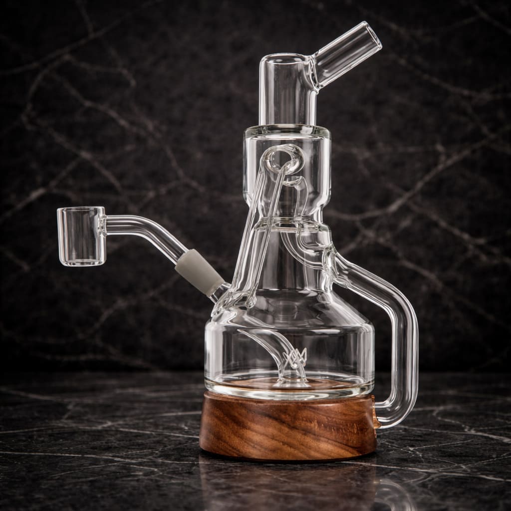 Clear glass recycler dab rig with wooden base shown from the side in dark studio lighting