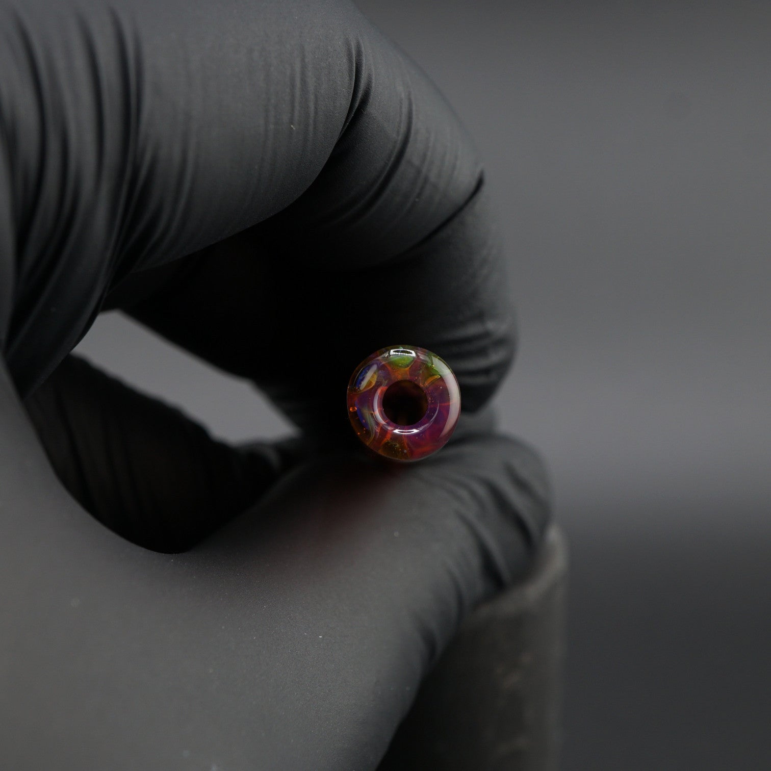 Iridescent borosilicate glass tip for joints close-up