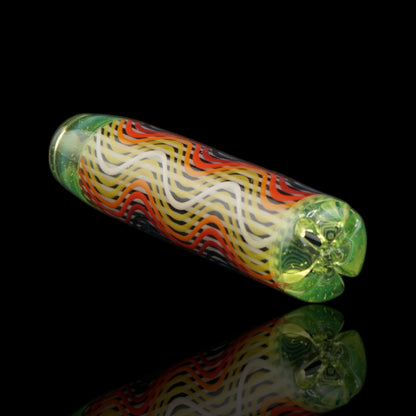 Angled view of the Leisure Glass Lime Flux glass tip showing red, orange, yellow and white Hypnotech waves with a lime green filter end