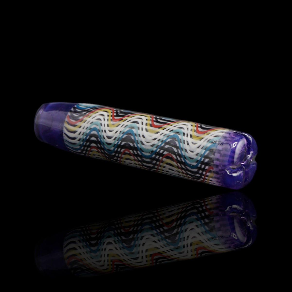 Angled view of the Leisure Glass Purple Haze glass tip showing white, black, blue, turquoise, red and yellow waves with purple ends