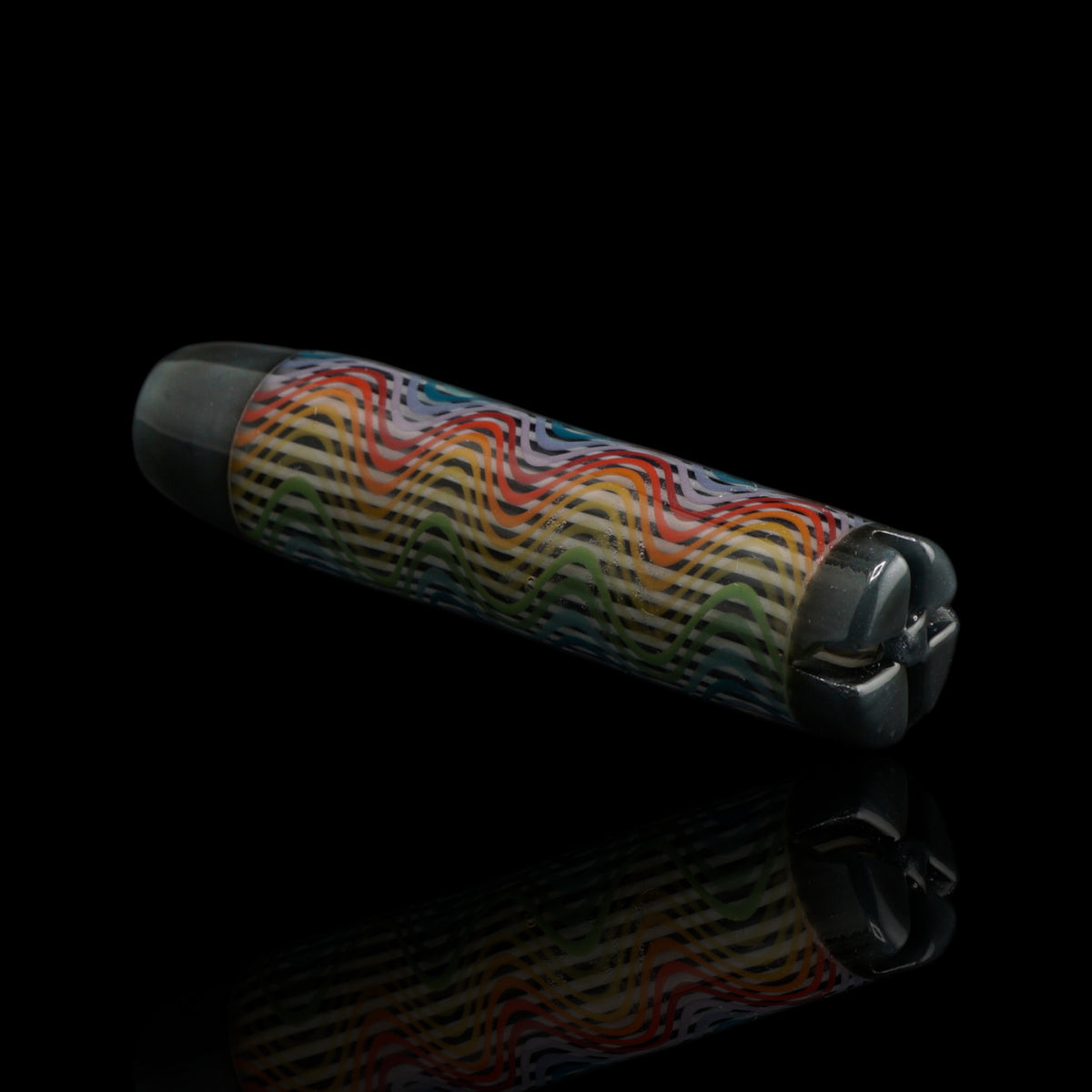 Angled view of the Leisure Glass Silver Spectrum glass tip showing its rainbow wave pattern and dark silver metallic end