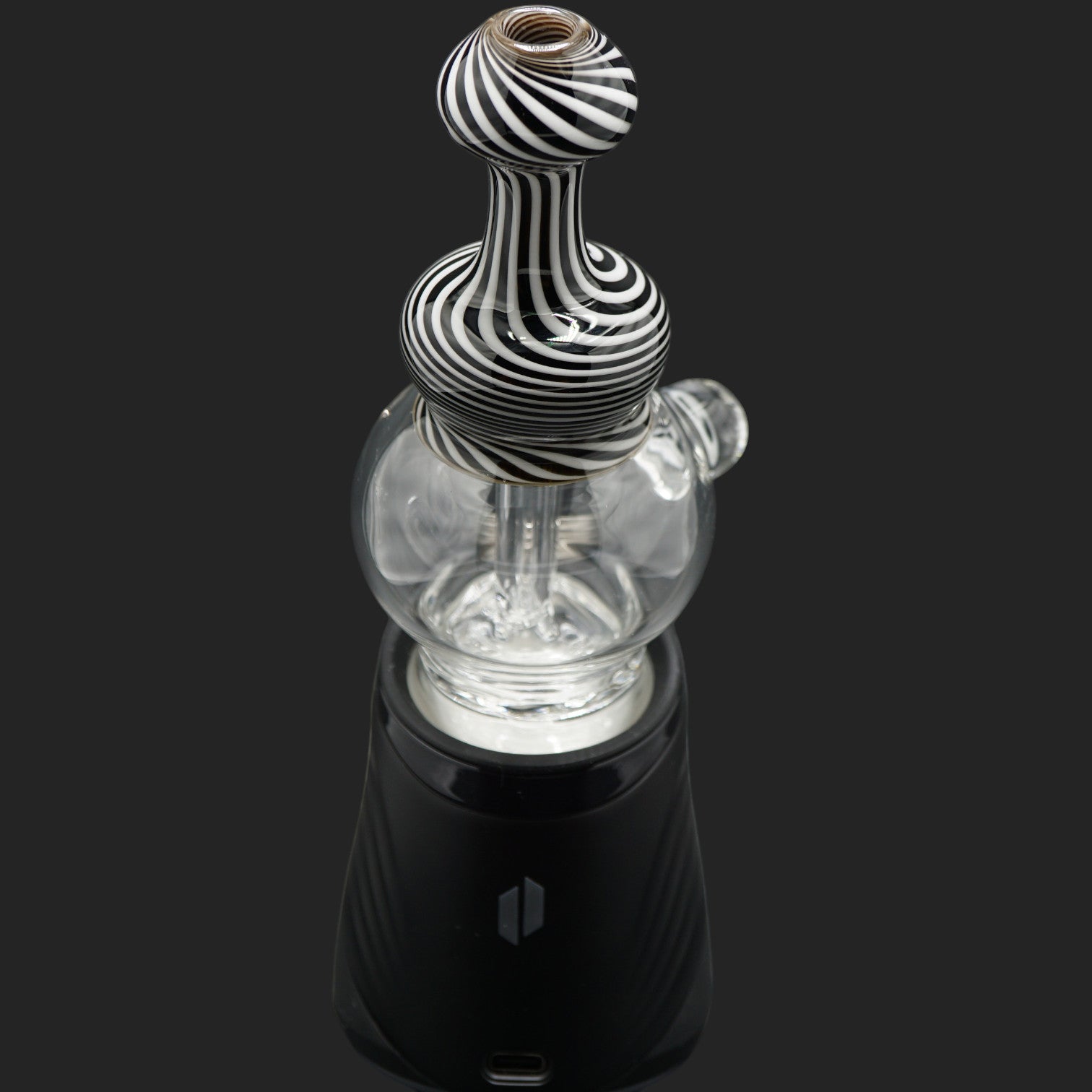 Front angle view of the Mind Blowing Glass Skull Spiral wet top featuring black and white spiral linework for the Puffco Peak Pro.