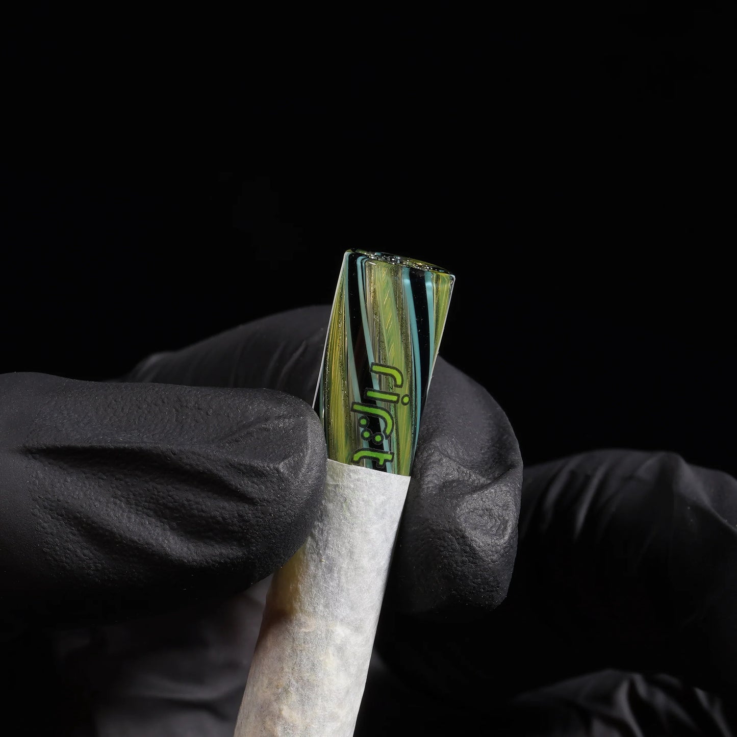 RipTip Captain Planet glass tip for joints with lime green aqua and black spiral design in use