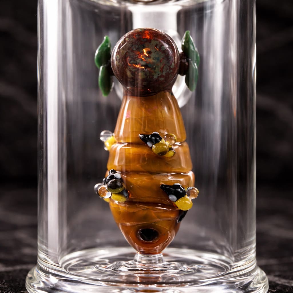 Close-up of handcrafted bee and honey lampwork inside Empire Glassworks Save the Bees dab rig