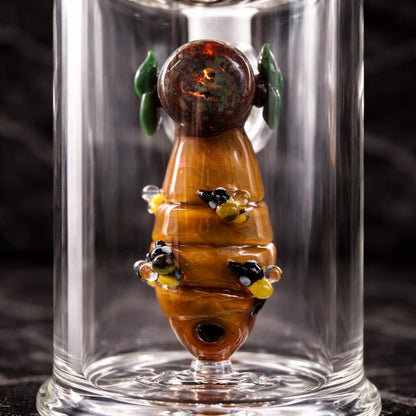Close-up of handcrafted bee and honey lampwork inside Empire Glassworks Save the Bees dab rig