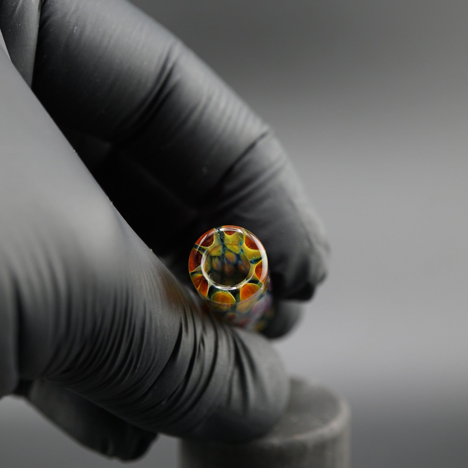 SteveHGlass Aurora Vein 11.8 mm glass tip held in hand showing the interior structure and iridescent multicolor glass design.