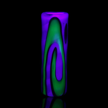 UV reactive Tyeglassarts Relic glass tip glowing bright green and purple under blacklight