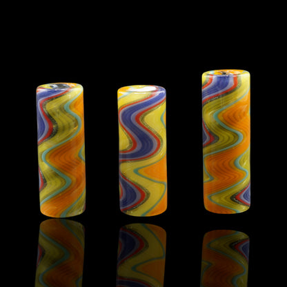 Three standing Tyeglassarts Sunset Pulse glass tip variants with colorful linework and gold sparkle details