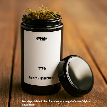 UV-Schutzglas aus Miron Violettglas mit offenem Deckel und Etikett auf Holztisch